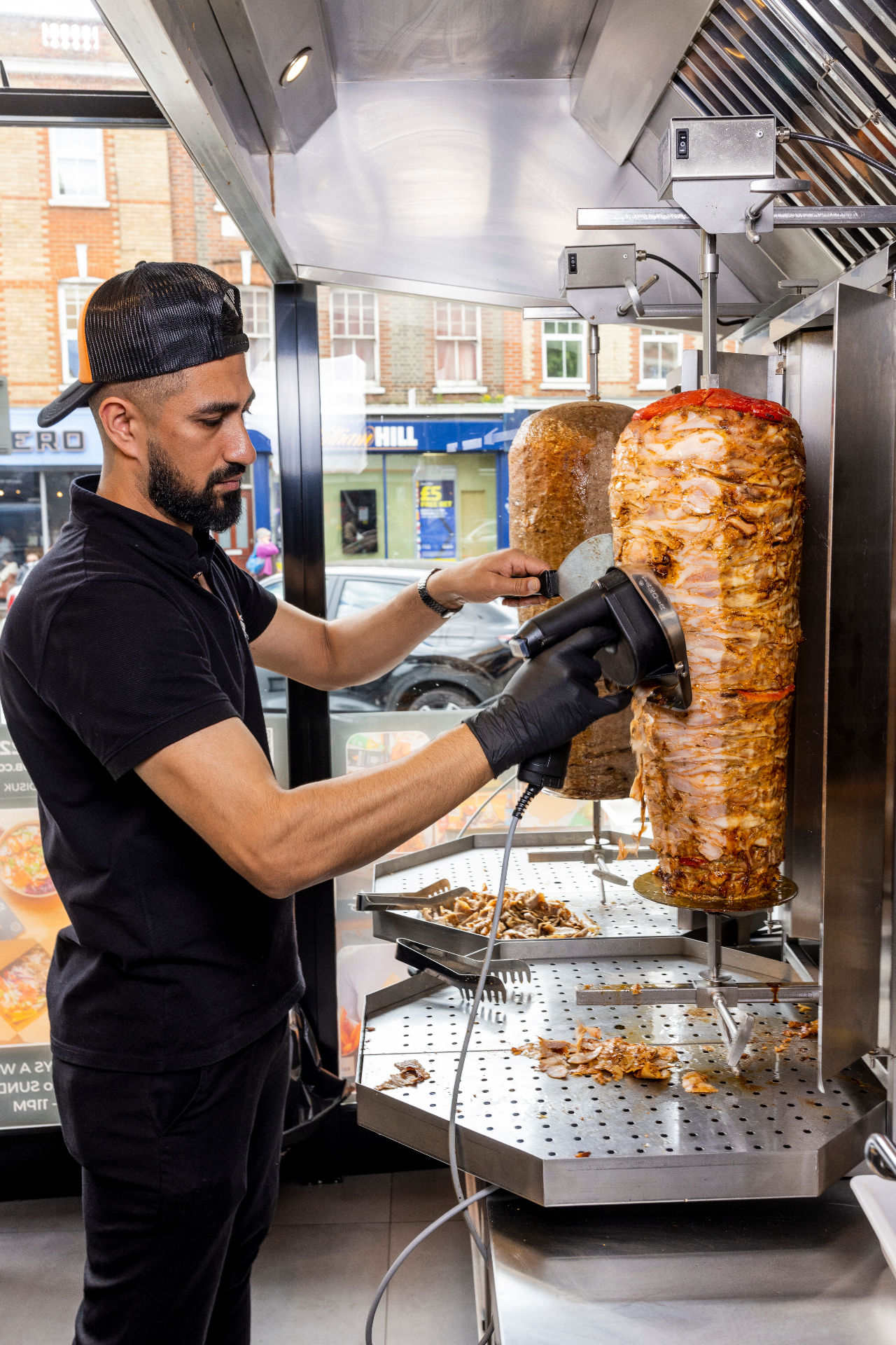 Brudis chef carving fresh doner from the vertical spit